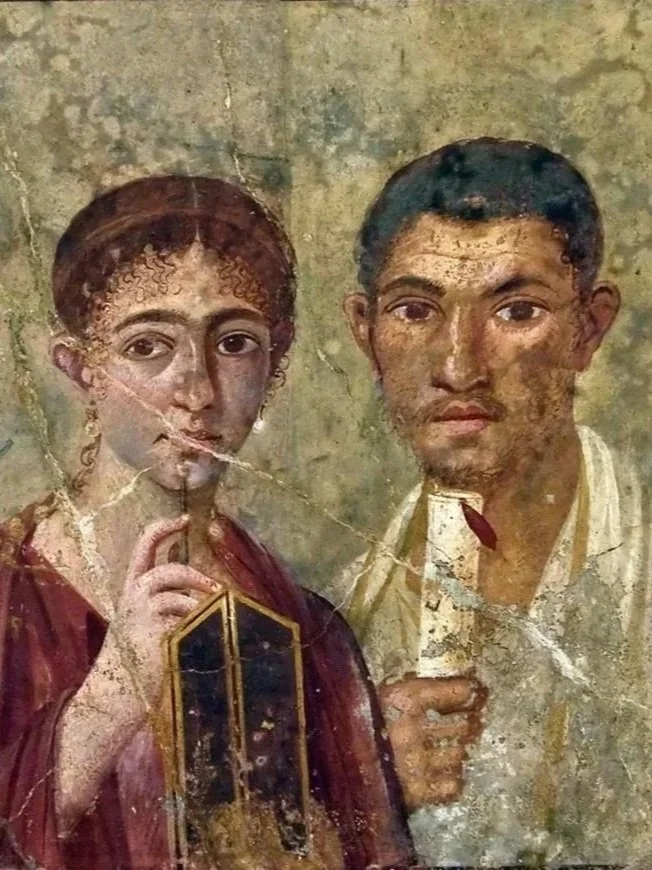 A weathered fresco of a woman and a man, both holding writing implements, with the woman making a gesture with her finger near her lips, and the man looking forward with a serious expression.