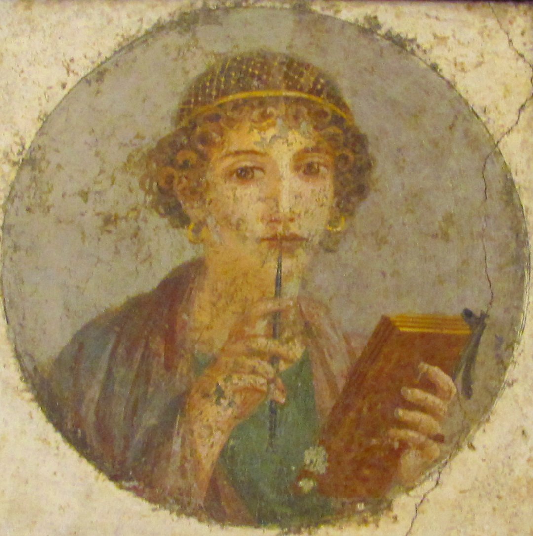 A painted ancient Roman portrait of a woman with curly hair, wearing a headband and earrings, holding a stylus in her mouth and a tablet in her hand.