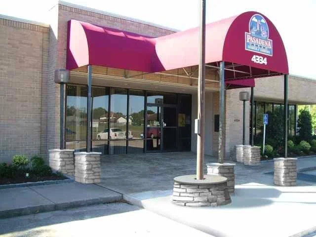 Entrance of a building with a pink fabric awning, glass doors, and a sign that reads 'Pasadena' with an address number 4384.