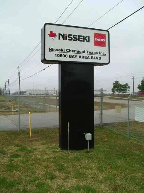 Outdoor sign for Nisseki Chemical Texas Inc. with logos for Nisseki and Eneos, located on Bay Area Blvd with overcast weather.