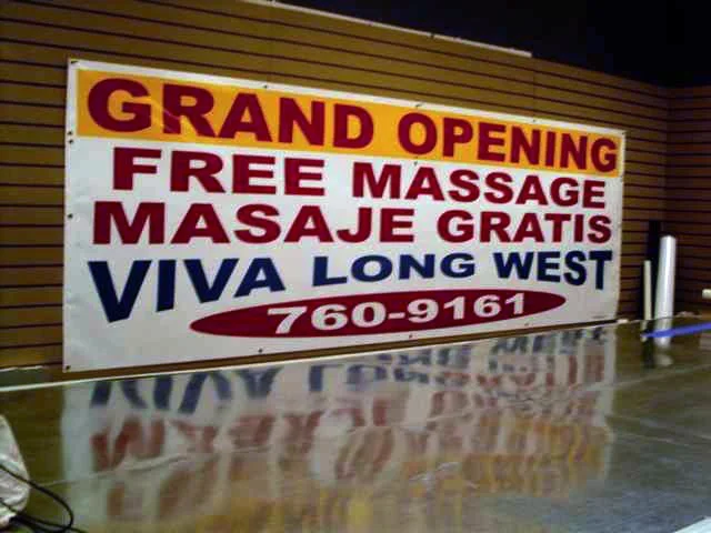 Sign announcing the grand opening of Viva Long West offering free massages, with a phone number 760-9161.