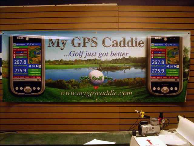 Banner promoting GPS Caddie for golf, featuring two GPS device screenshots and a scenic golf course image, with contact website www.mygpscaddie.com.
