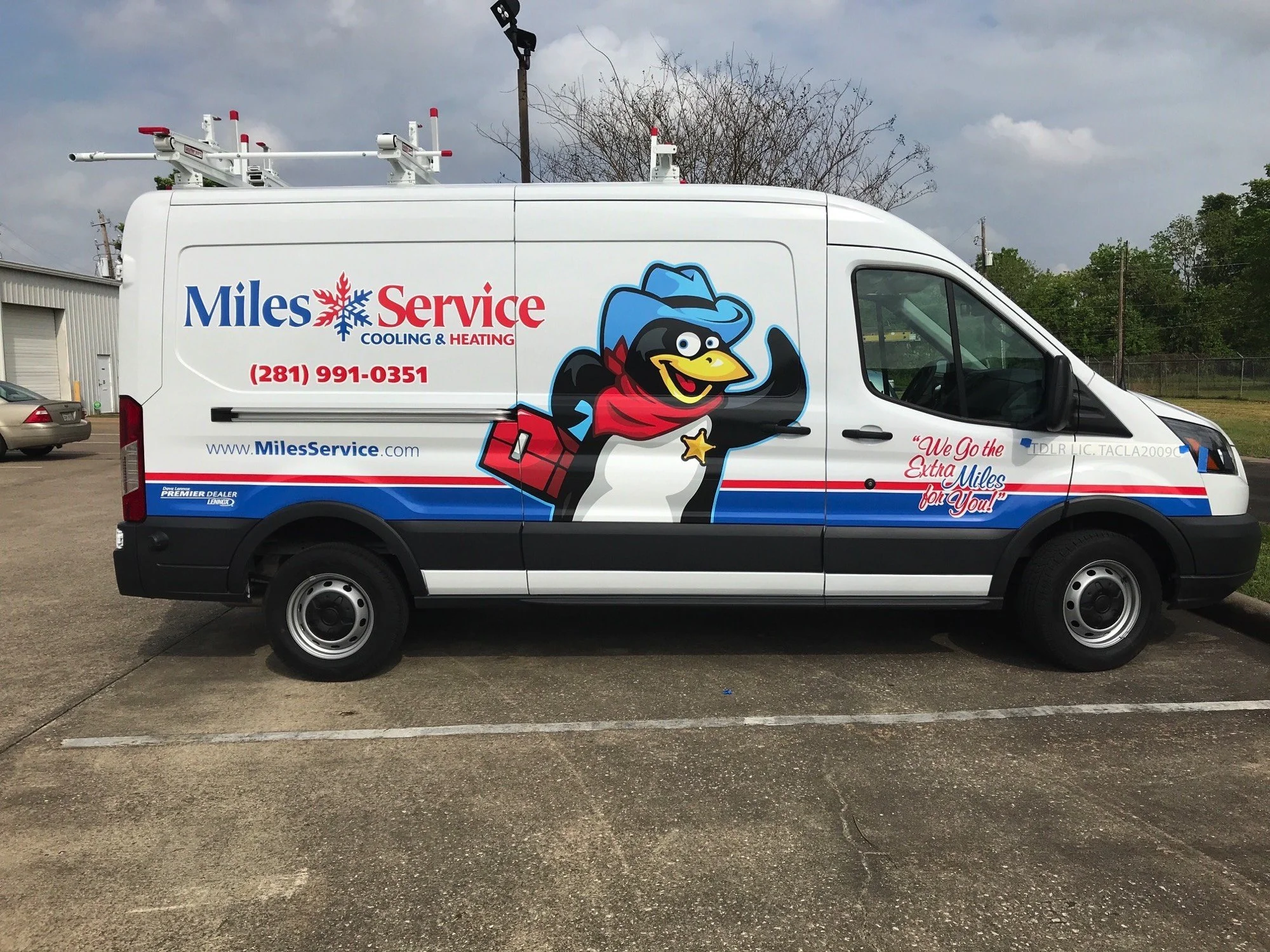 White service van with Mile Service logo, cartoon character of a cheerful bird in a cowboy hat, red scarf, and star badge, parked in a lot against a cloudy sky, with trees and a building in the background.