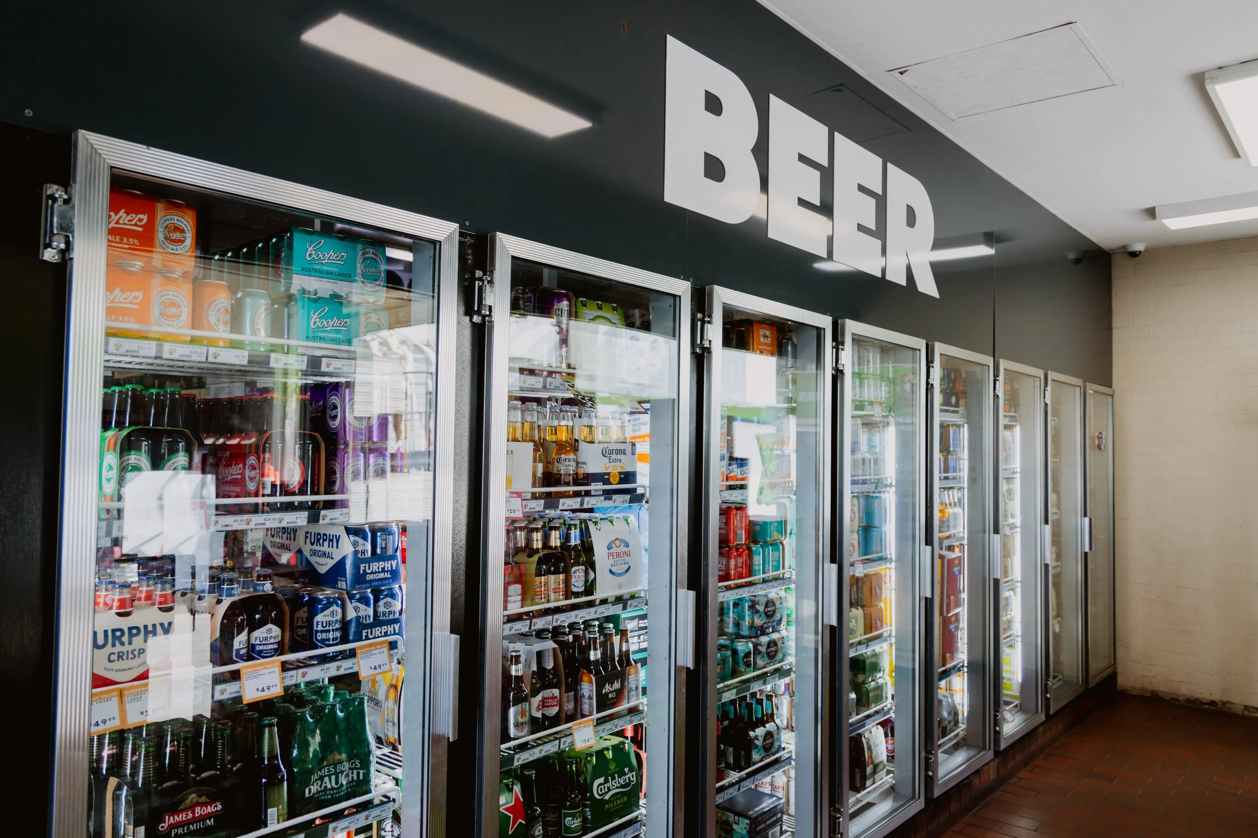 Refrigerators stocked with various alcoholic beverages at the Bottle Shop at The Racecourse Hotel Werribee