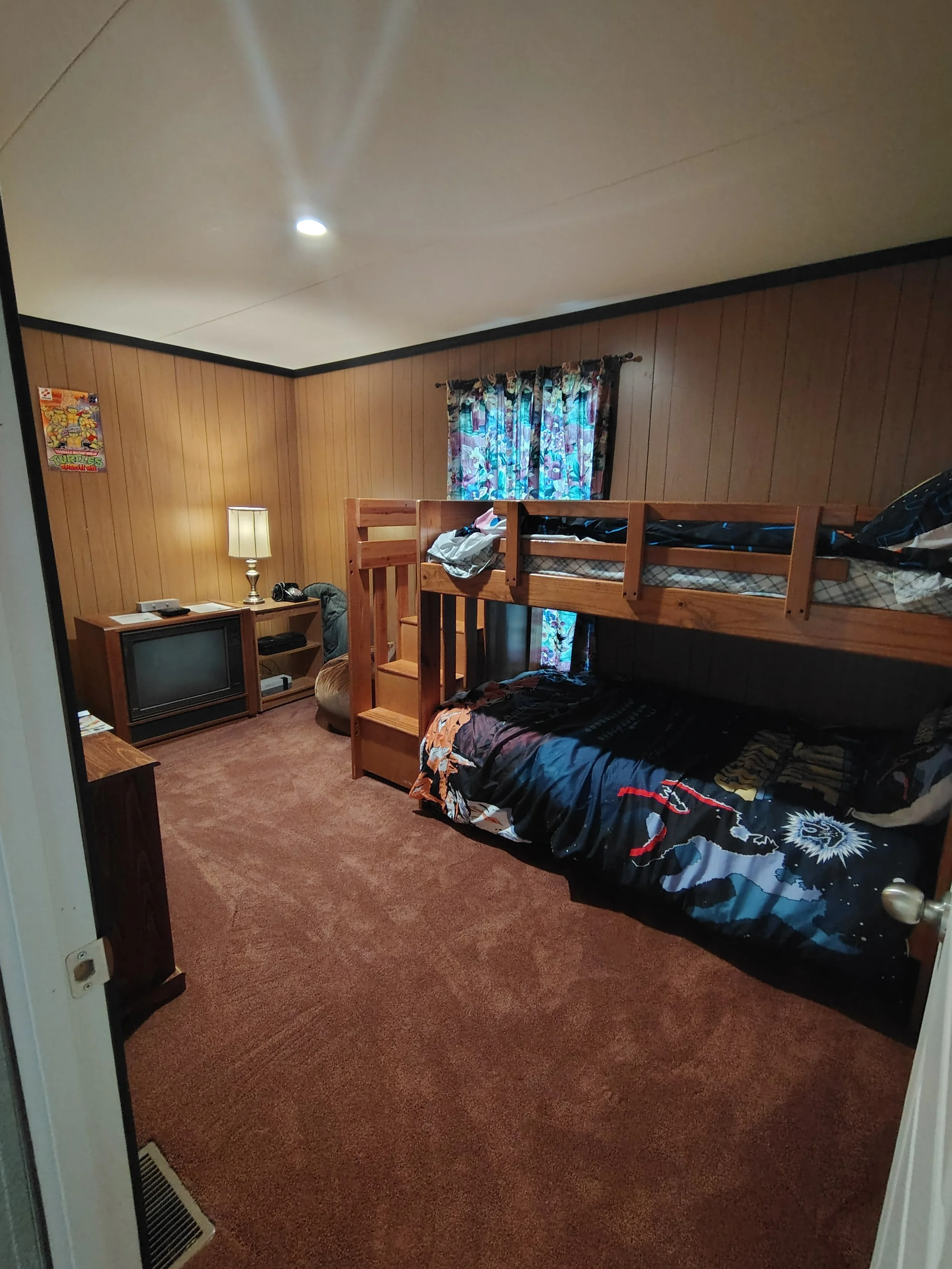 The retro room has a sturdy wooden bunk bed and extra air mattress. 