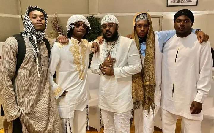 Five men (Israelites) dressed in traditional African-inspired clothing standing together indoors. New Legacy Initiative. New Legacy, Inc.