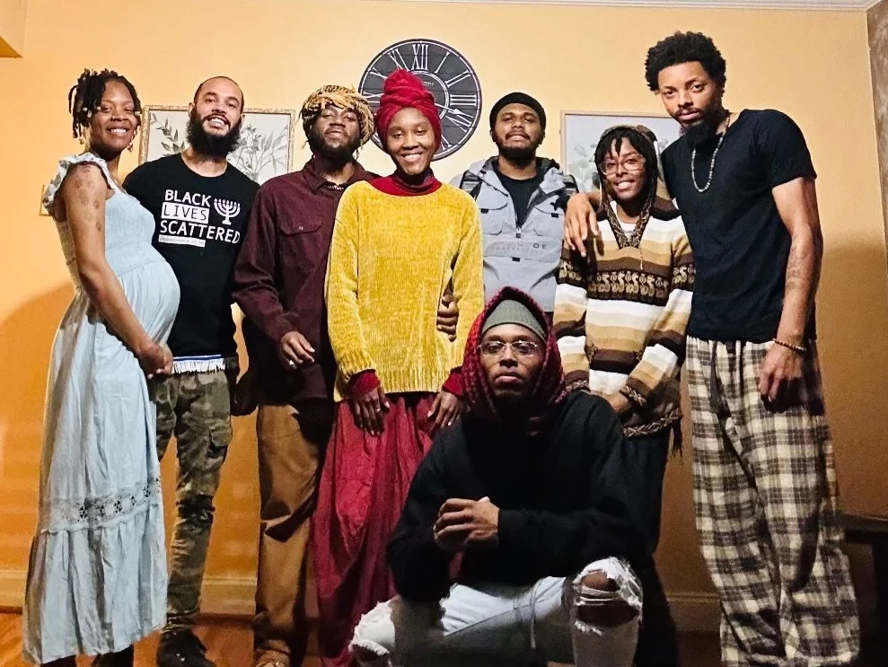 A diverse group of eight (Israelites) posing together. New Legacy Initiative. New Legacy, Inc.
