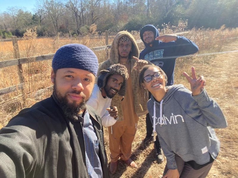 Five Israelites outdoors on a sunny day, taking a selfie. New Legacy Initiative. New Legacy, Inc.