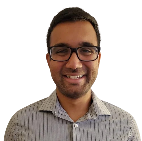 A smiling man with glasses and dark hair wearing a gray striped button-up shirt.