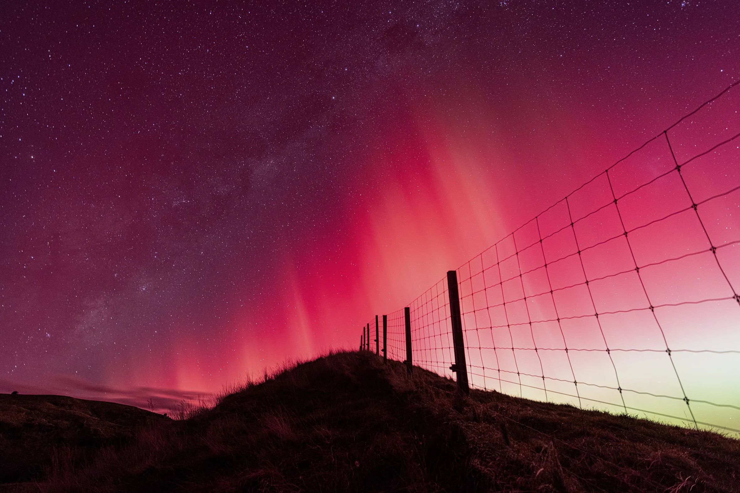 Aurora Australis and the milky Way over the fields in Maraetotara