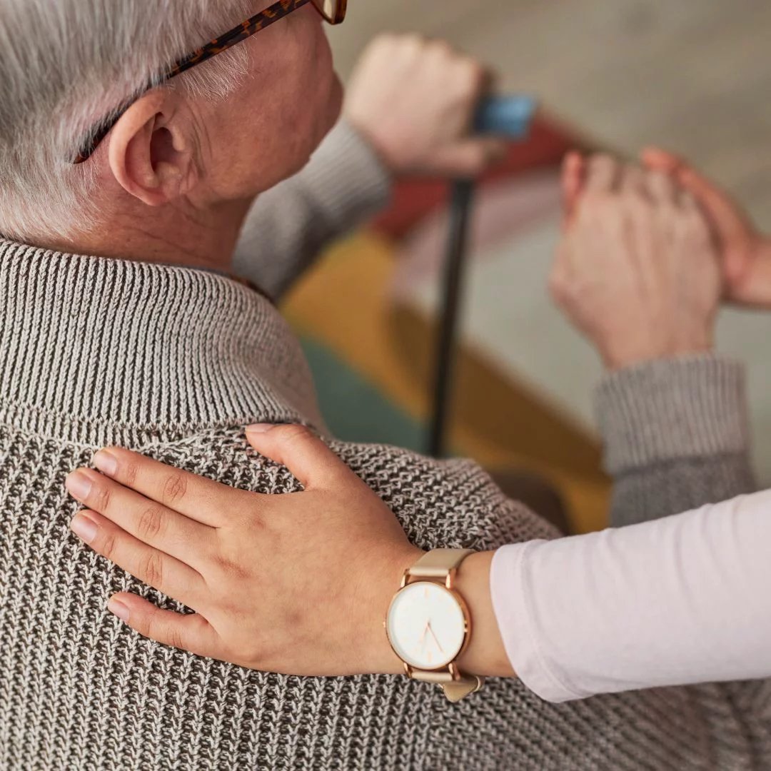 Physician resting her hand on a patient