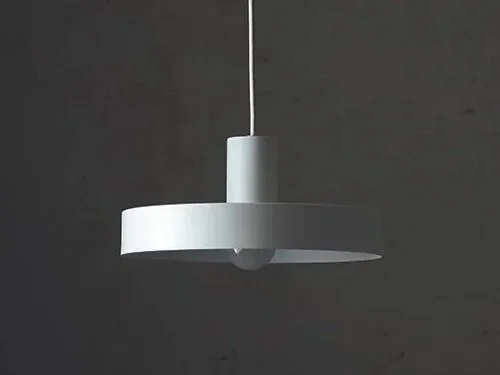 Modern, white ceiling pendant lamp hanging against a dark wall.