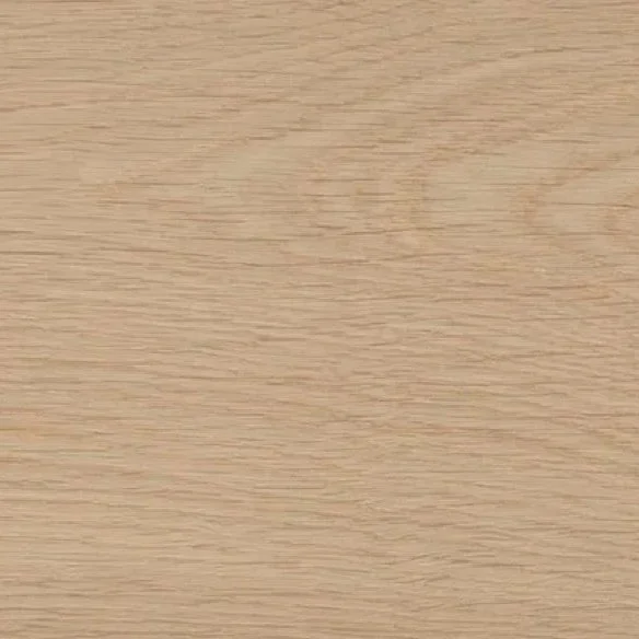 A close-up of a light wood surface or table with visible wood grain.