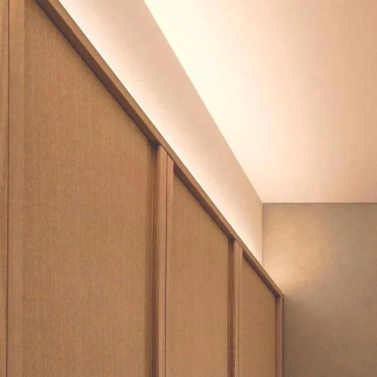Close-up view of wooden sliding closet doors in a room with minimal decor.