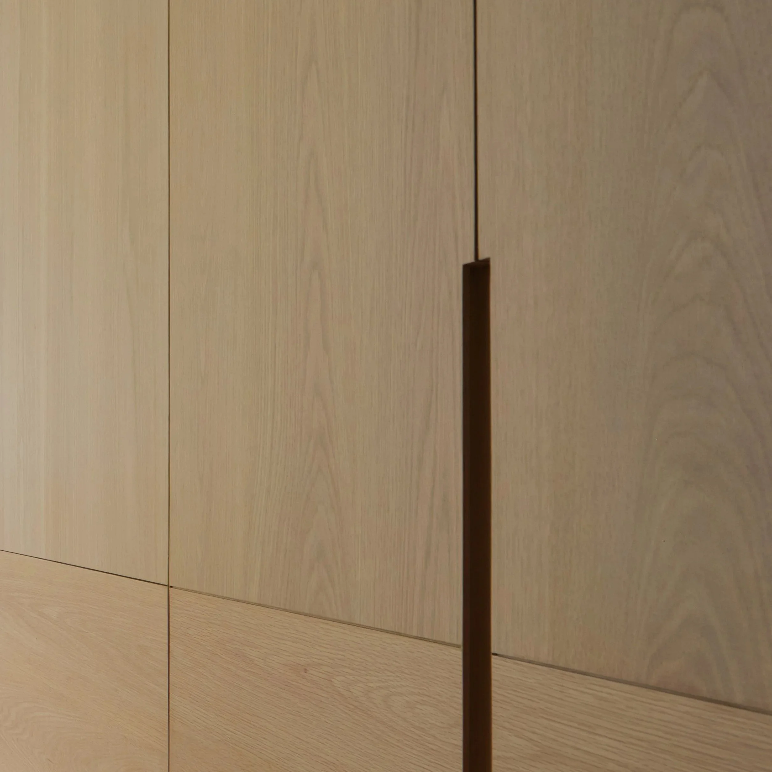 Close-up of wooden panels with vertical black gaps between them.