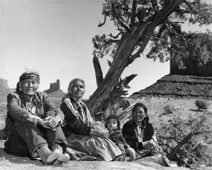 Navajo family sitting on ground by tree- Monument Valley, 1960's.jpg