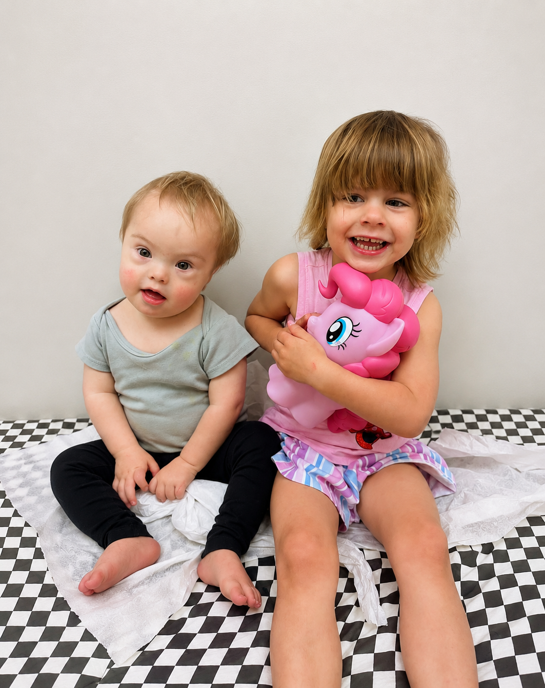 Boy with Down Syndrome and his older sister at the doctors office.