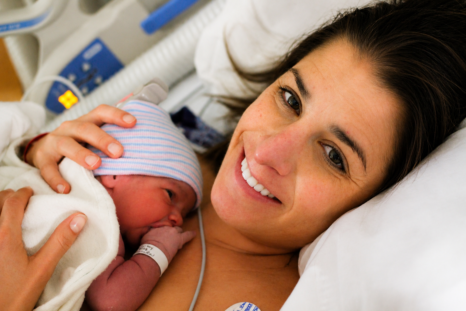 Woman holding newborn son who will later be diagnosed with autism.
