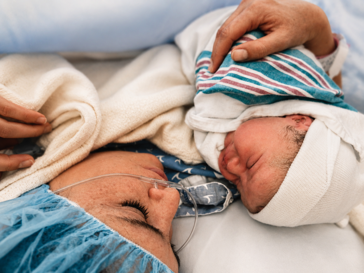 A woman, in the precious moments after becoming a mom.