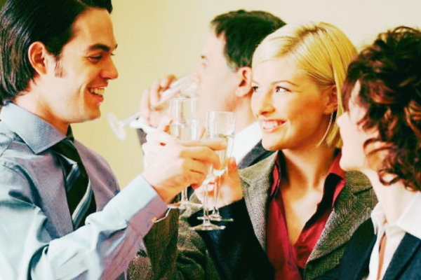 work colleagues drinking champagne at christmas party