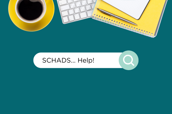 Yellow notebook, coffee, computer keyboard at top of screen. Green background. "SCHADS help!" in search bar. SCHADS Award training.