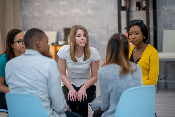 Small team of colleagues having a facilitated discussion