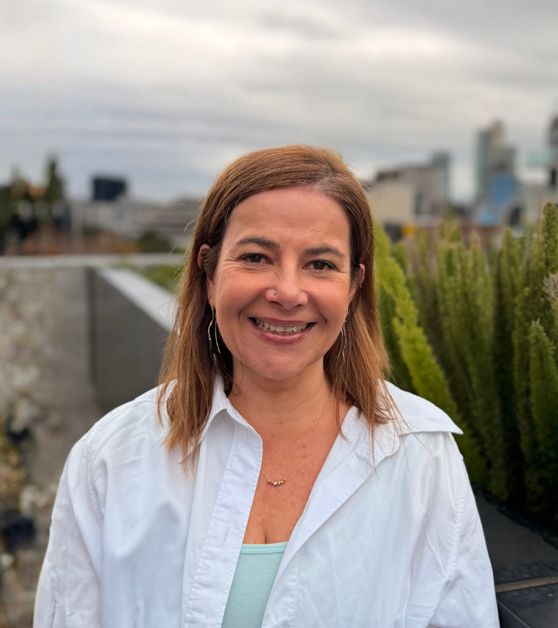 Woman smiling outdoor urban setting.