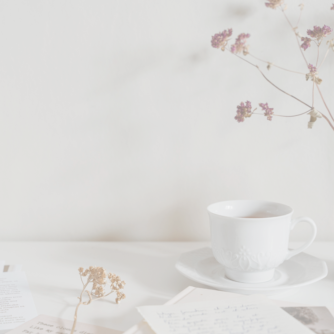 White desk background with notes, cup of tea and dried flowers
