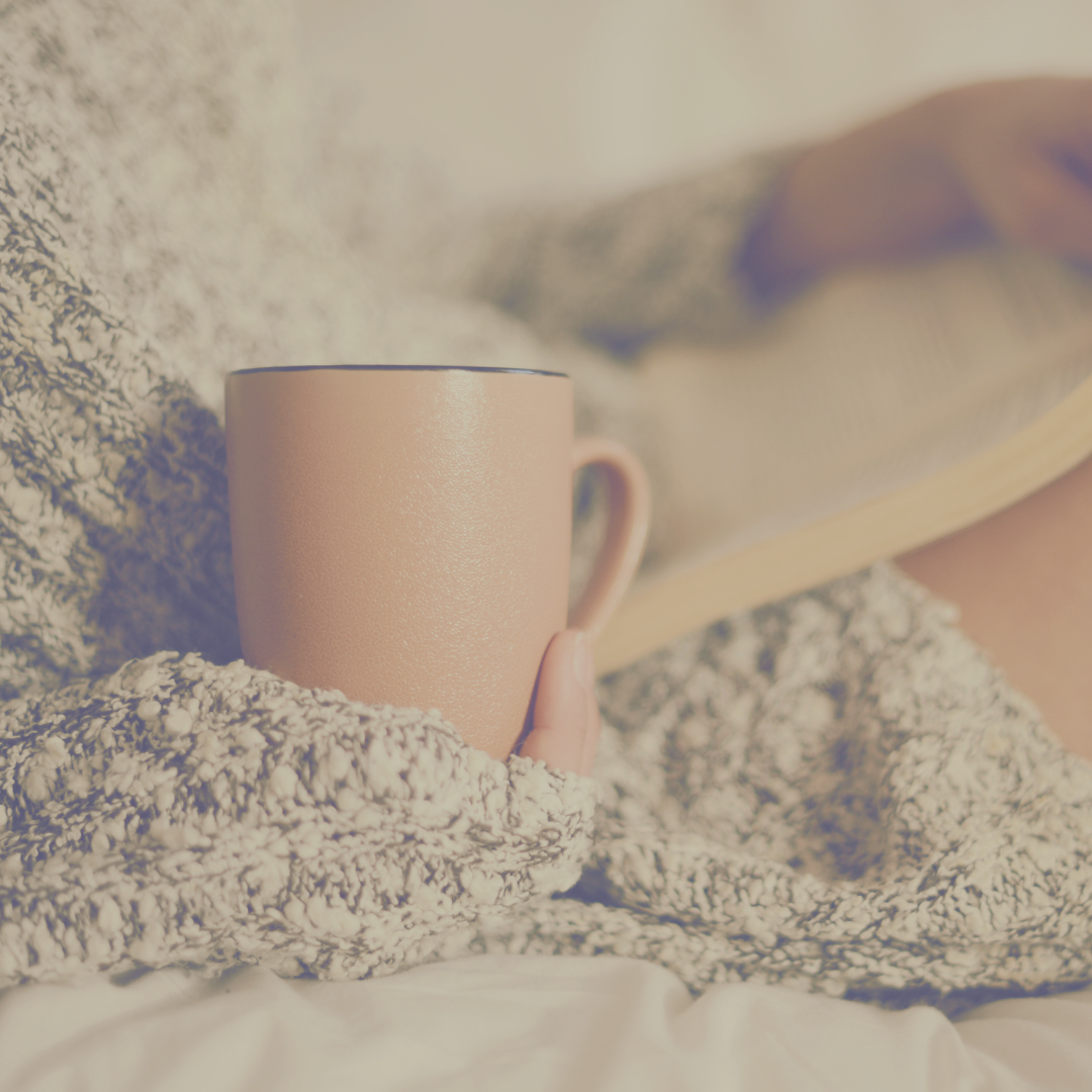 Lady resting with a cup of tea and a book