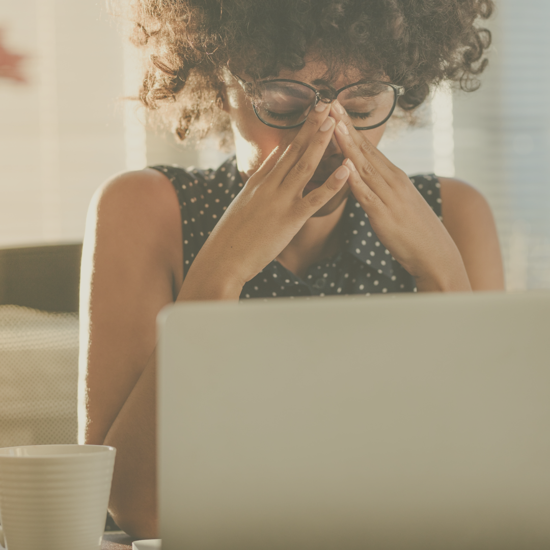 Stressed upset woman at work desk with laptop