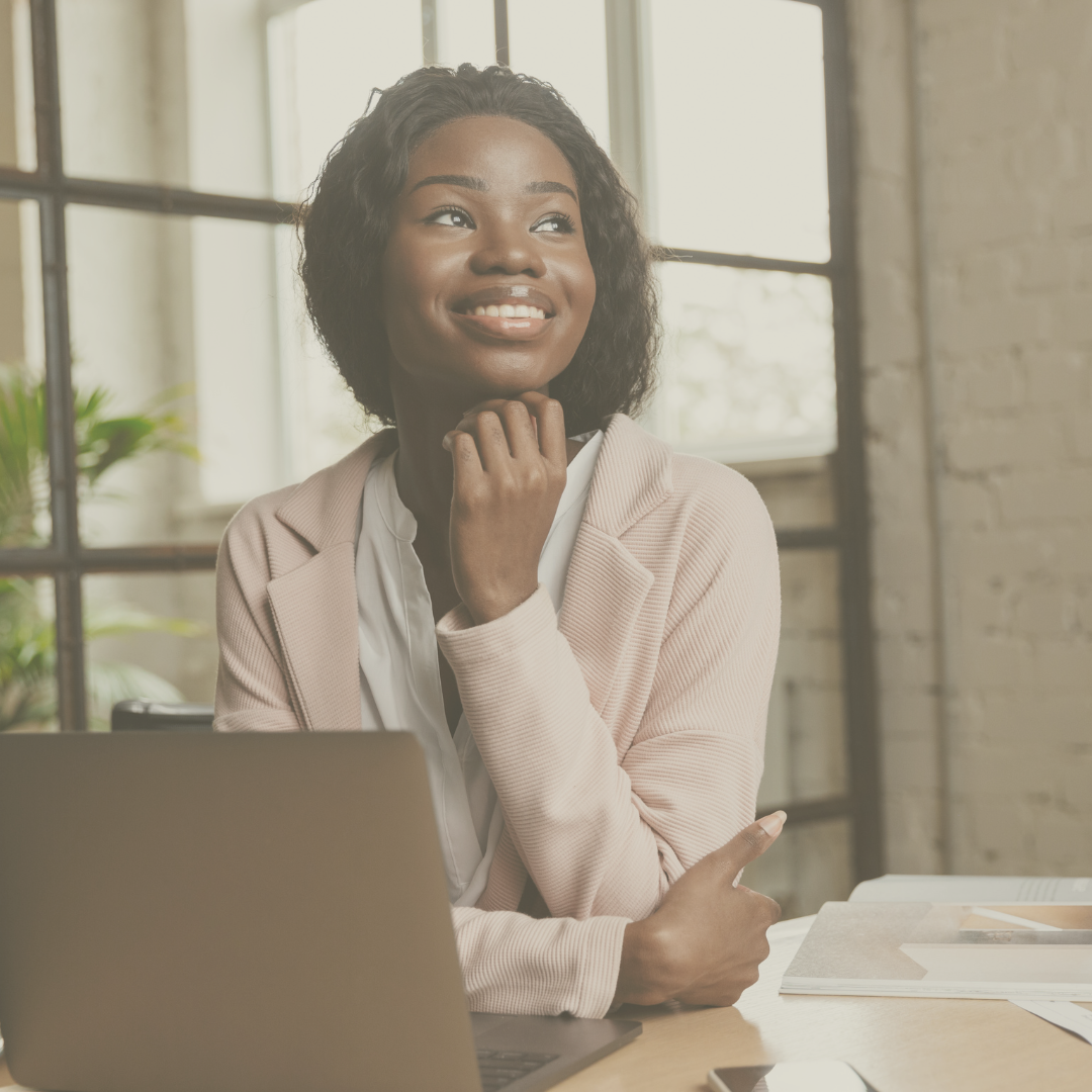 Smiling woman by laptop at work