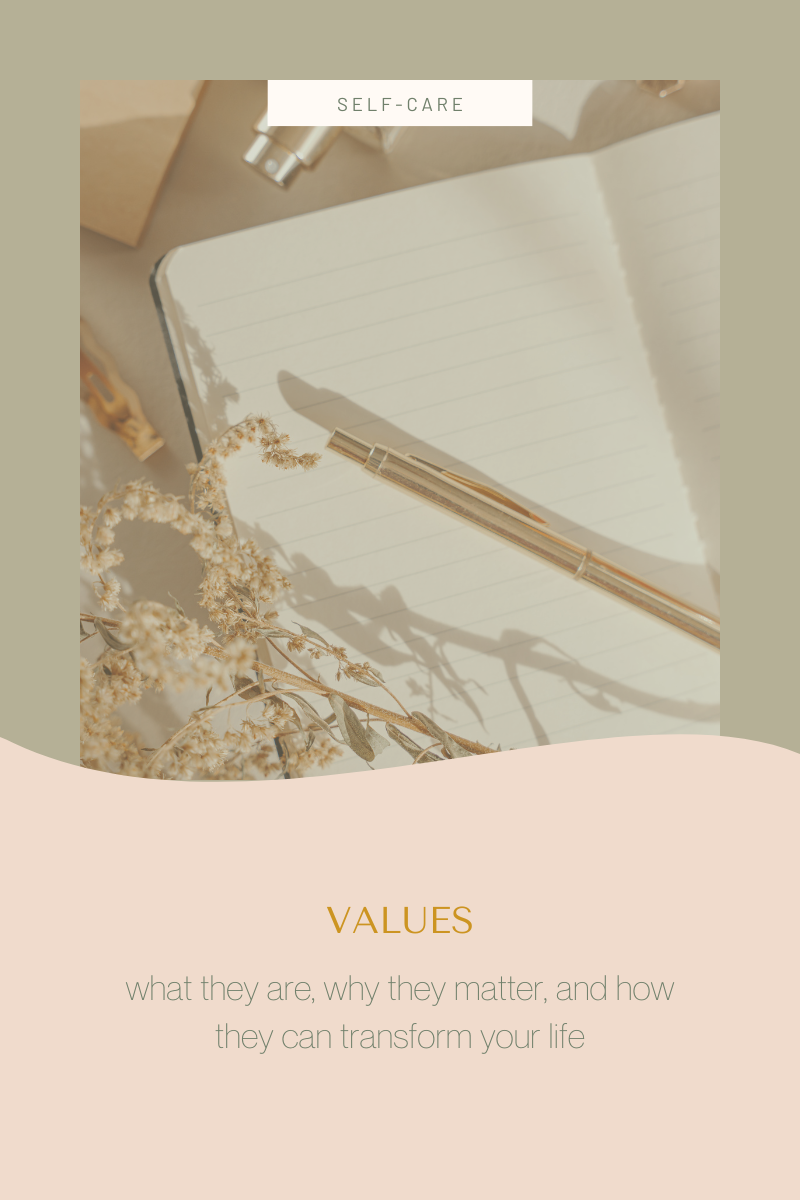 Gold pen resting on a blank page of a notebook, dried flowers off to the side