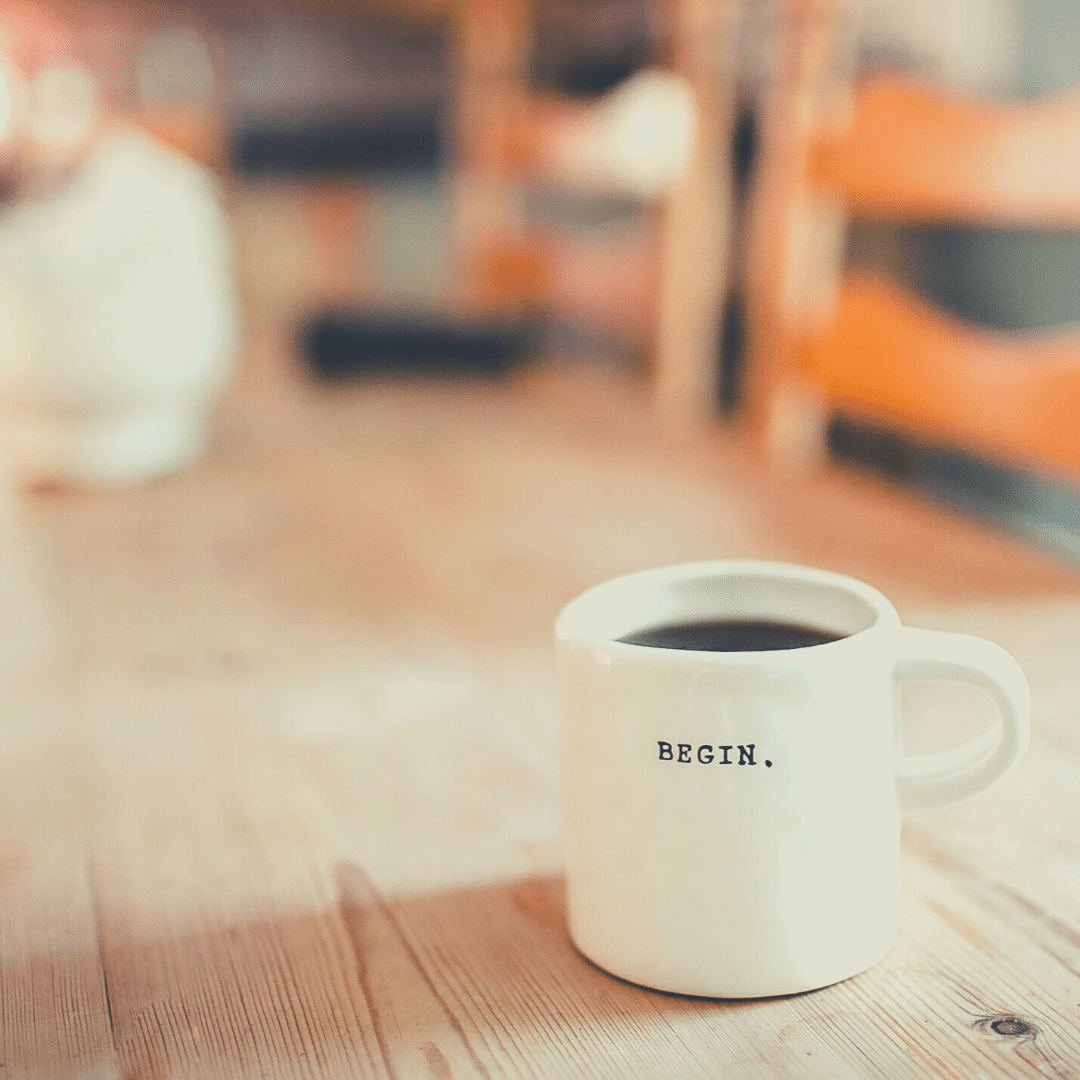 Mug-on-table-with-the-word-begin-written-on-it