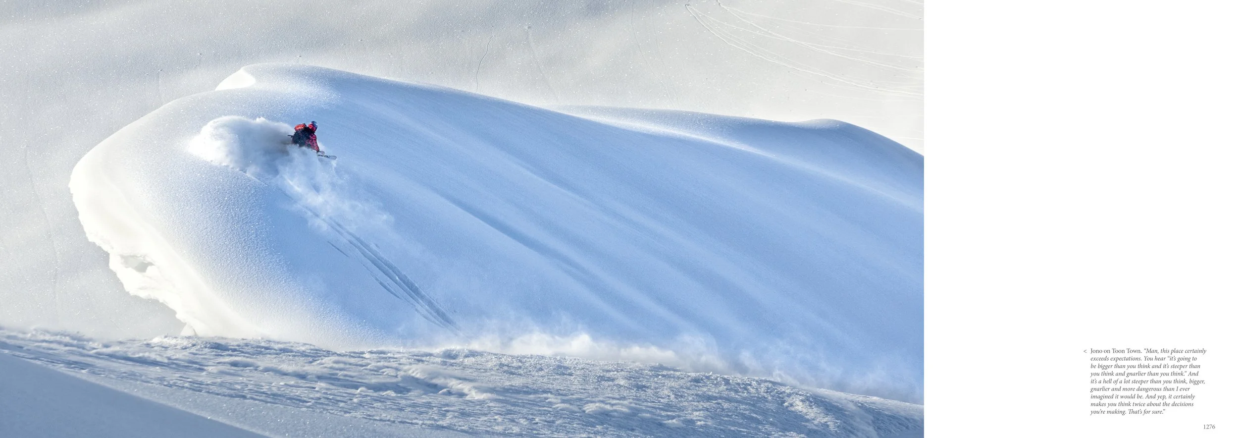 A skier in pink gear skiing through deep powder snow in a snowy landscape. Snow is flying around as the skier carves a turn on the slope.