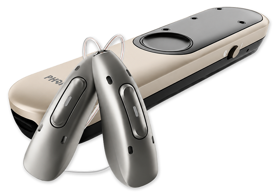 A hearing aid device and a remote control placed on a dark background.