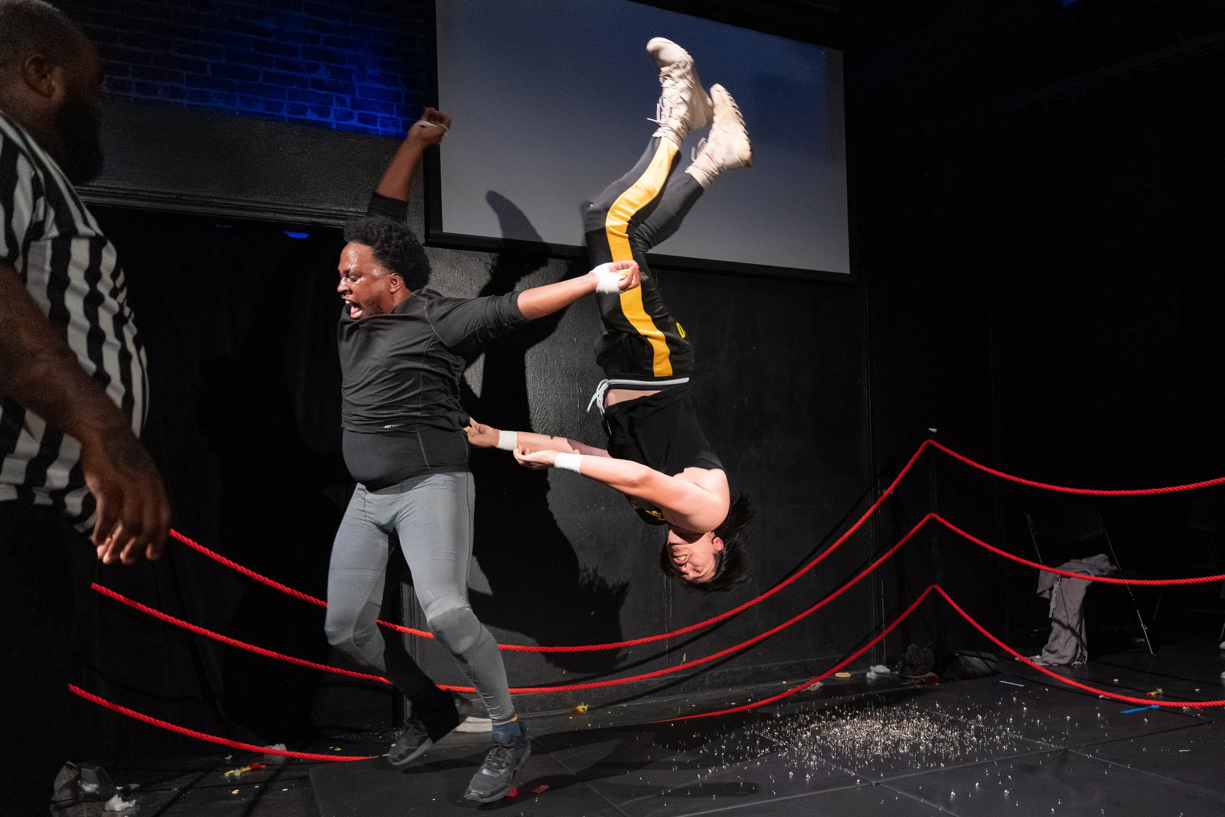 Jacquis Neal and PJ McCormick performing a live improv wrestling comedy set on stage at The Upright Citizens Brigade in Hollywood, captured by a local comedy photographer.