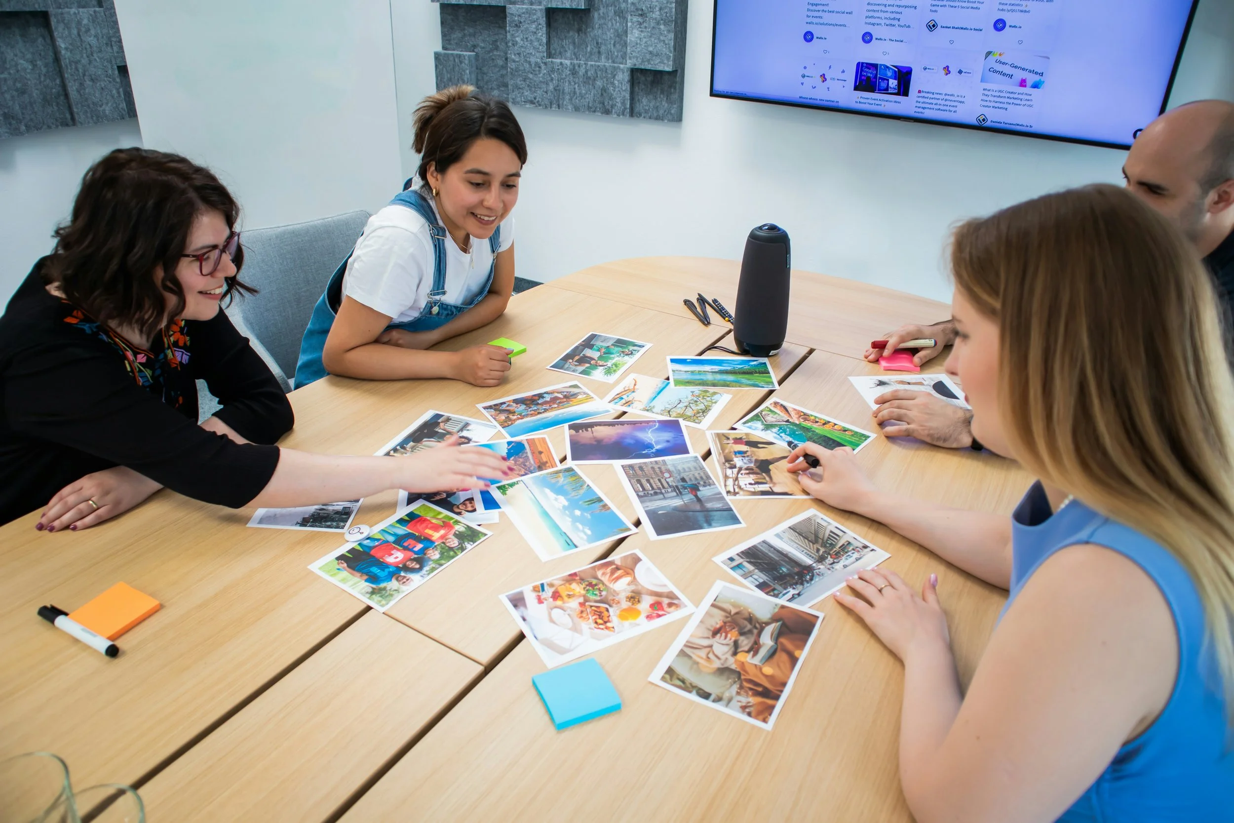 Family members gathered around a table sharing photographs and memories.