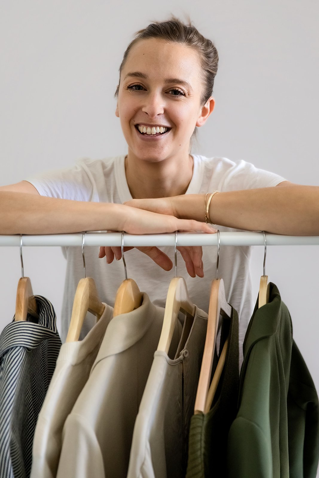 The Closet Reset founder sorting wardrobe.