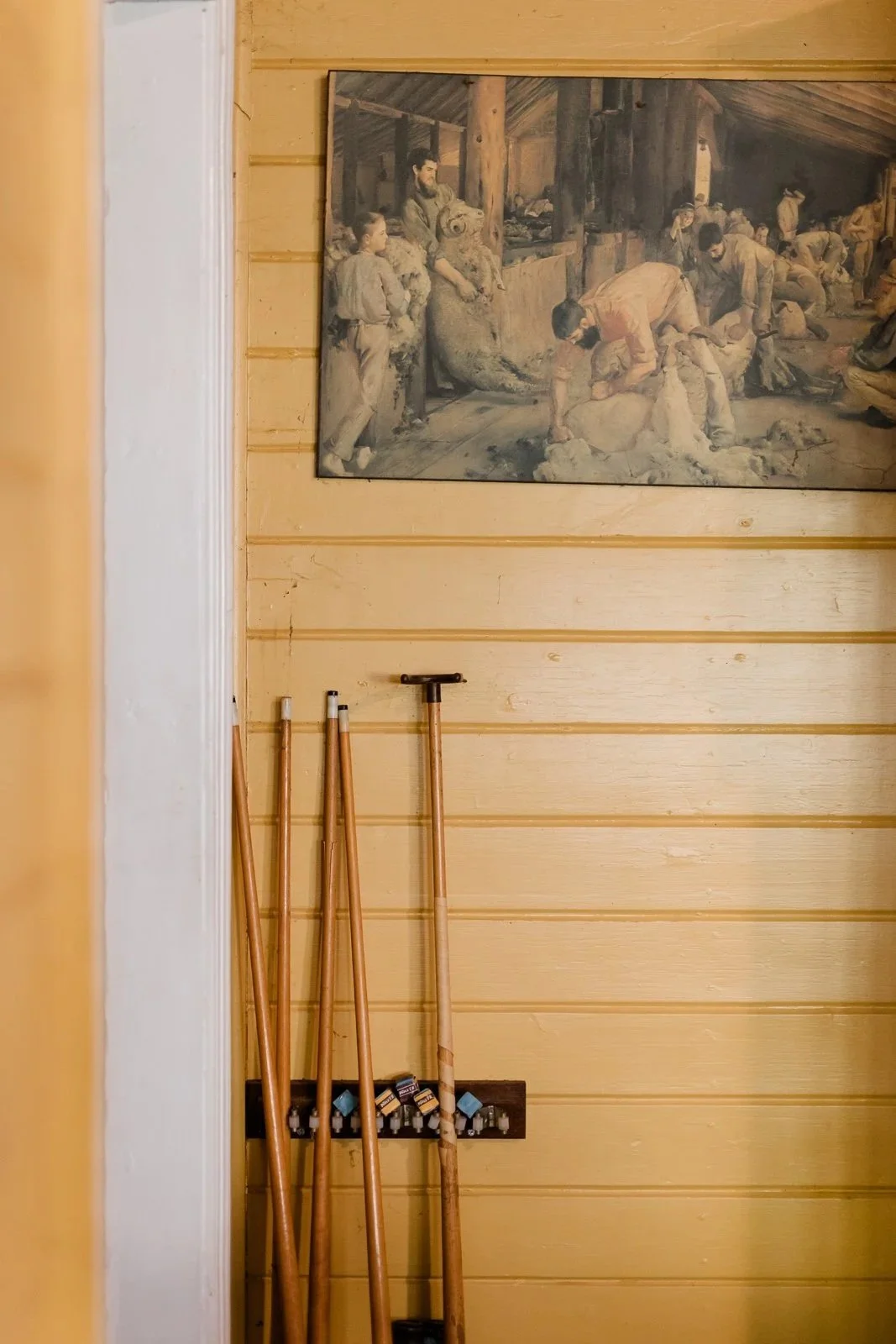 Pool cues leaning against the wall