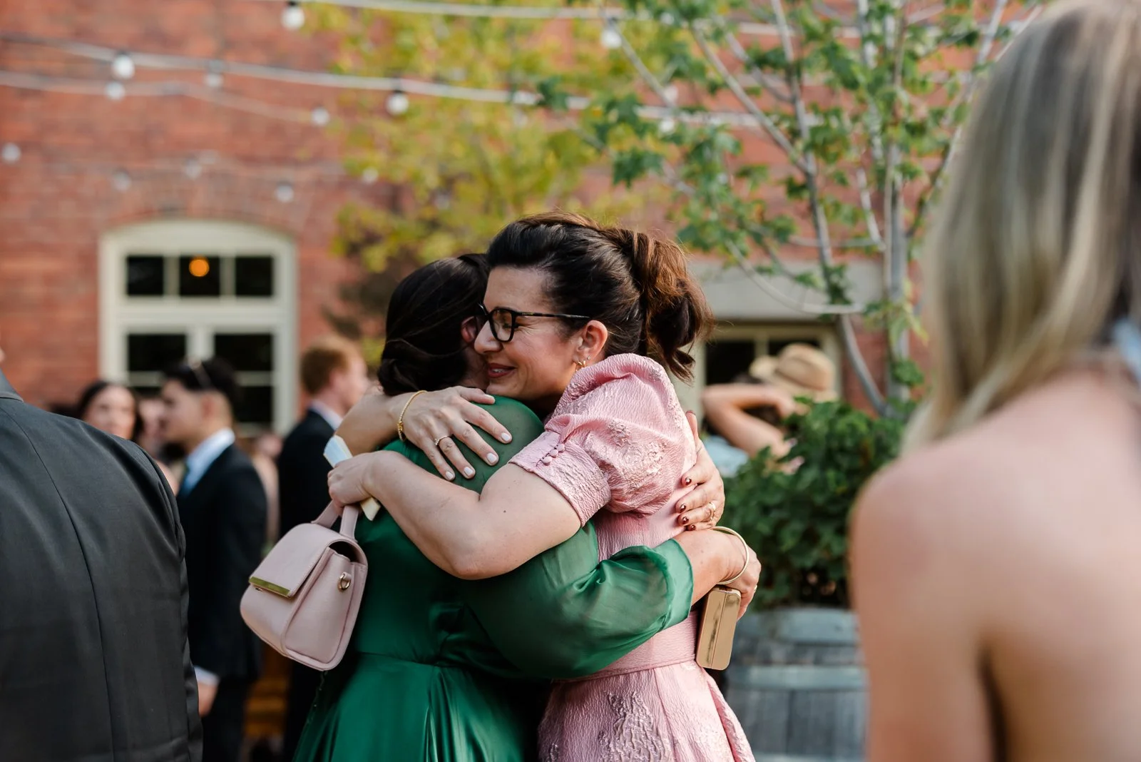 Wedding guests sharing a heartfelt hug during the celebrations at a relaxed regional wedding in Victoria.