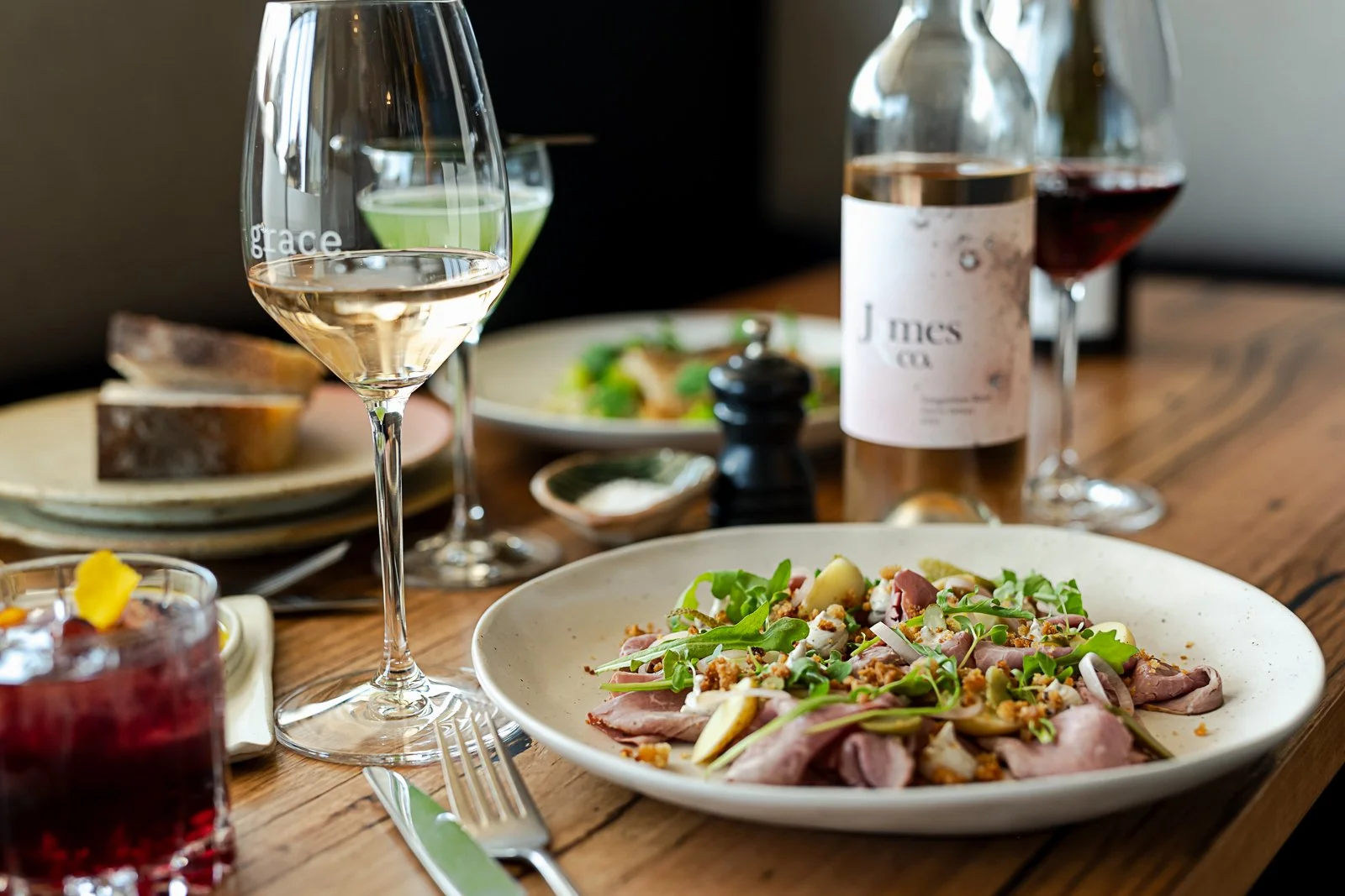 Wine, cocktails and a shared dish on a table at Grace Bar + Eatery in Rutherglen.