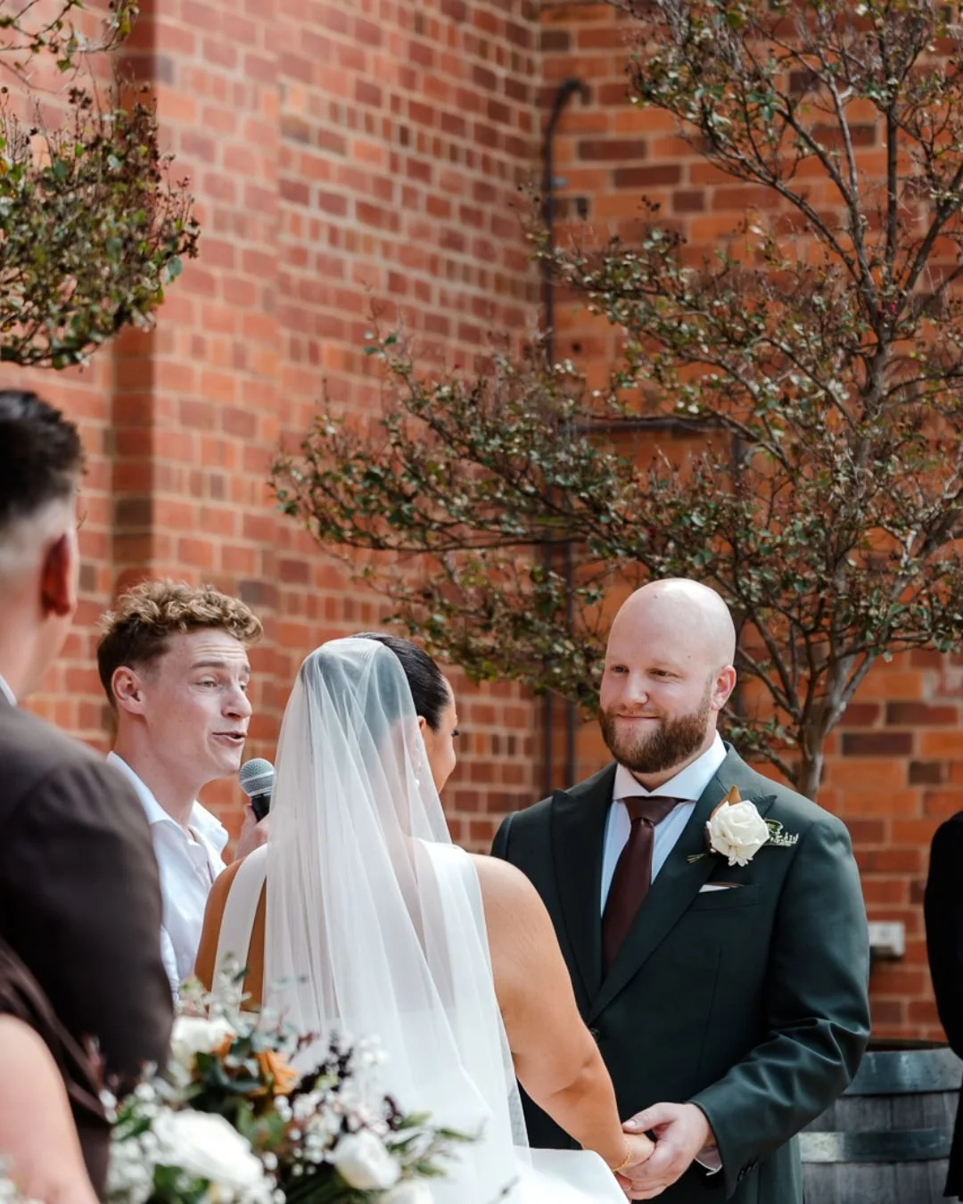 The emotion of the ceremony captured as the couple exchange vows surrounded by family and friends.