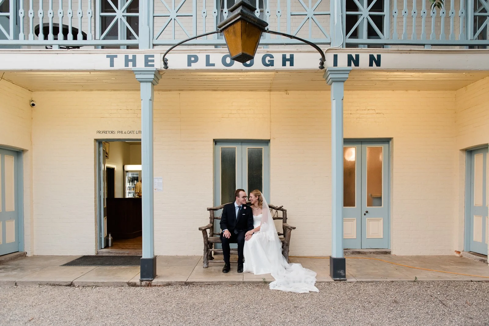 bride and groom sit together outside the plough inn tarrawingee