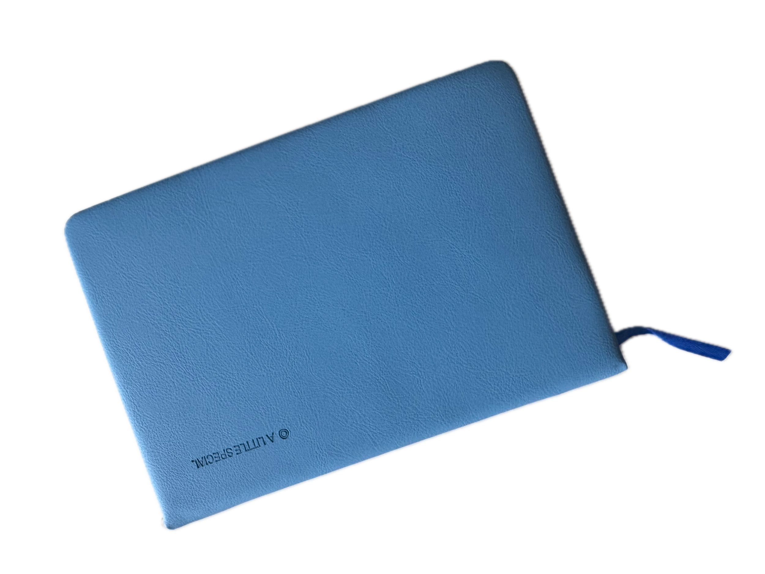 A blue hardcover book with textured cover lying diagonally on a surface.