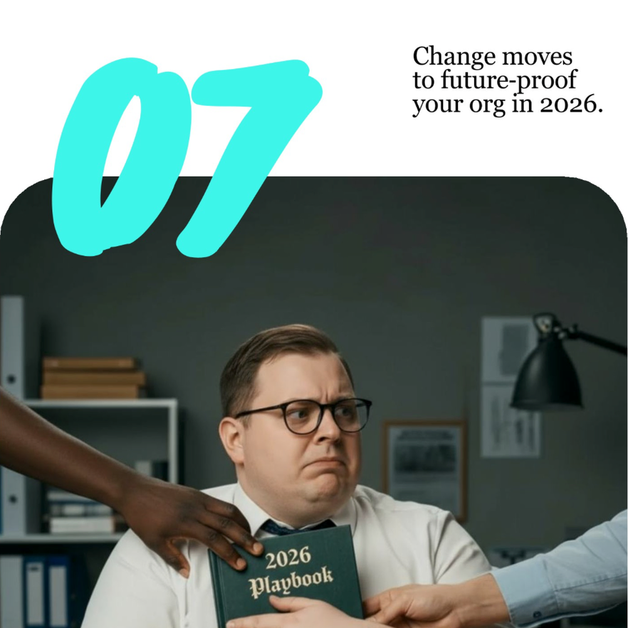 Man with glasses and a serious expression holds a 2026 playbook as a dark-skinned hand touches his shoulder, in an office setting with shelves and a lamp in the background.
