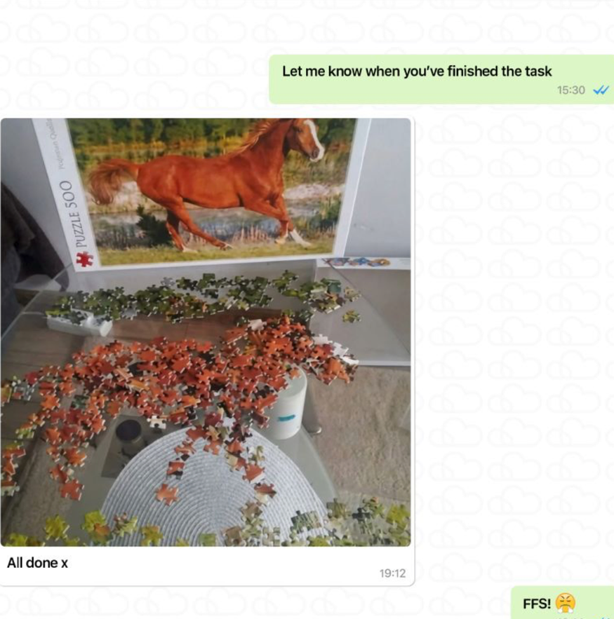 Puzzle of a brown horse running in a field with green trees in the background, partially assembled with pieces scattered around, on a table near a white wall and a chair.