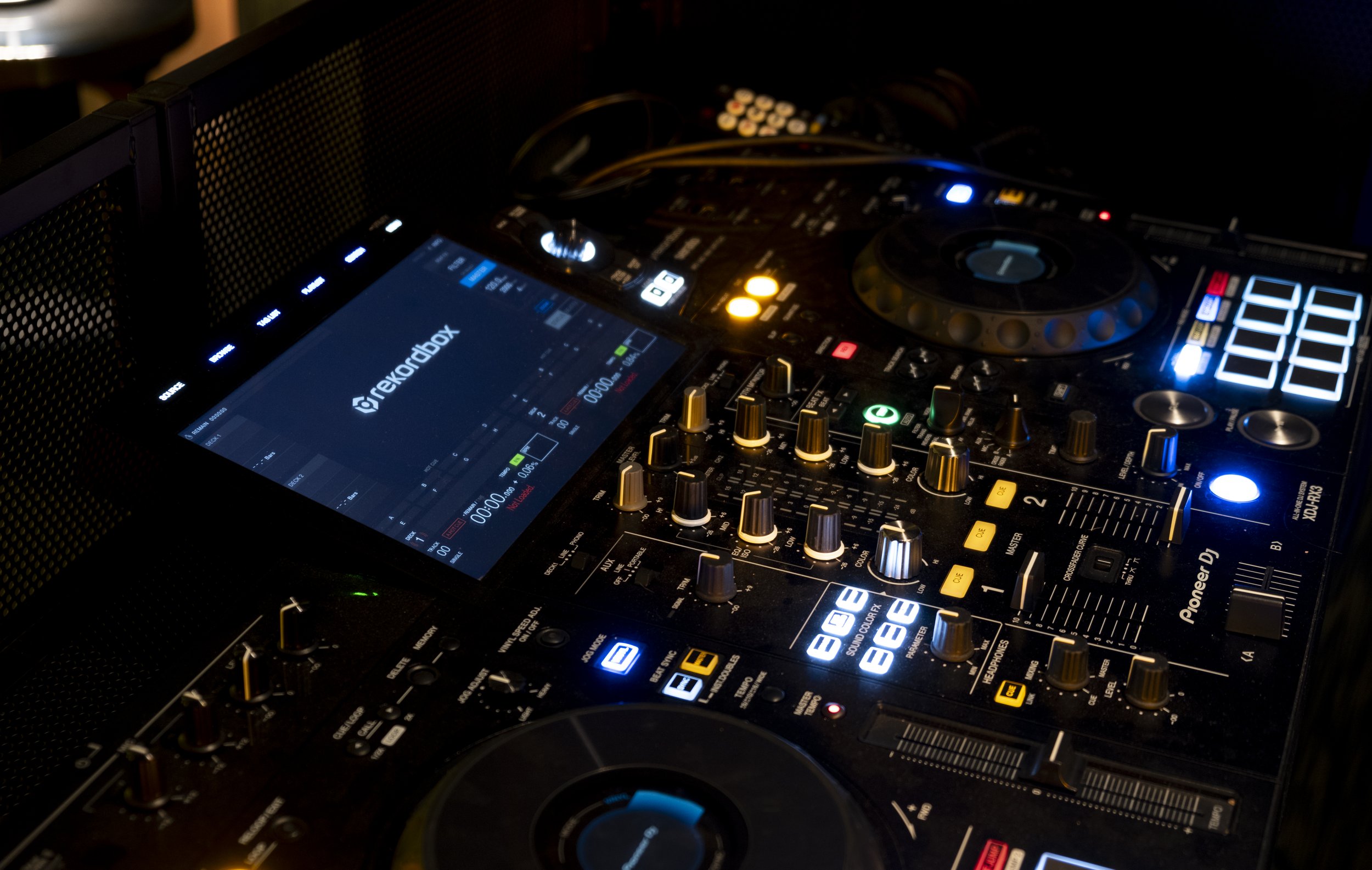 DJ mixer with illuminated controls and a digital display