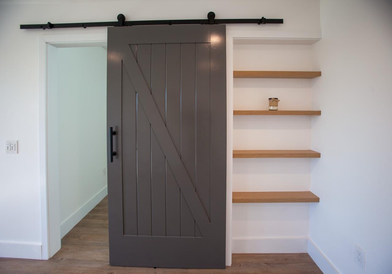 Space saving Barn Door and white oak floating shelves