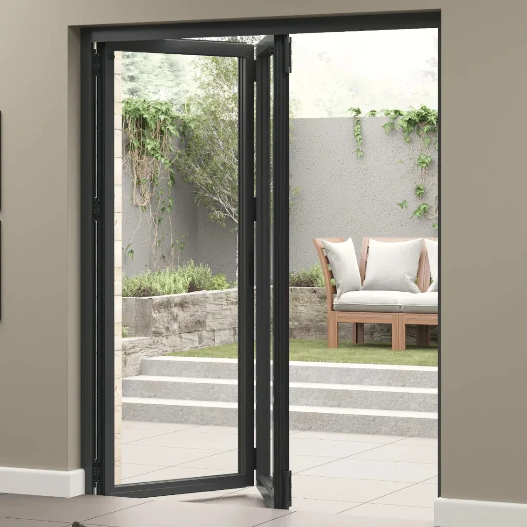 Open glass patio door opening to a small outdoor patio with a cushioned wooden bench, greenery, and a gray wall.