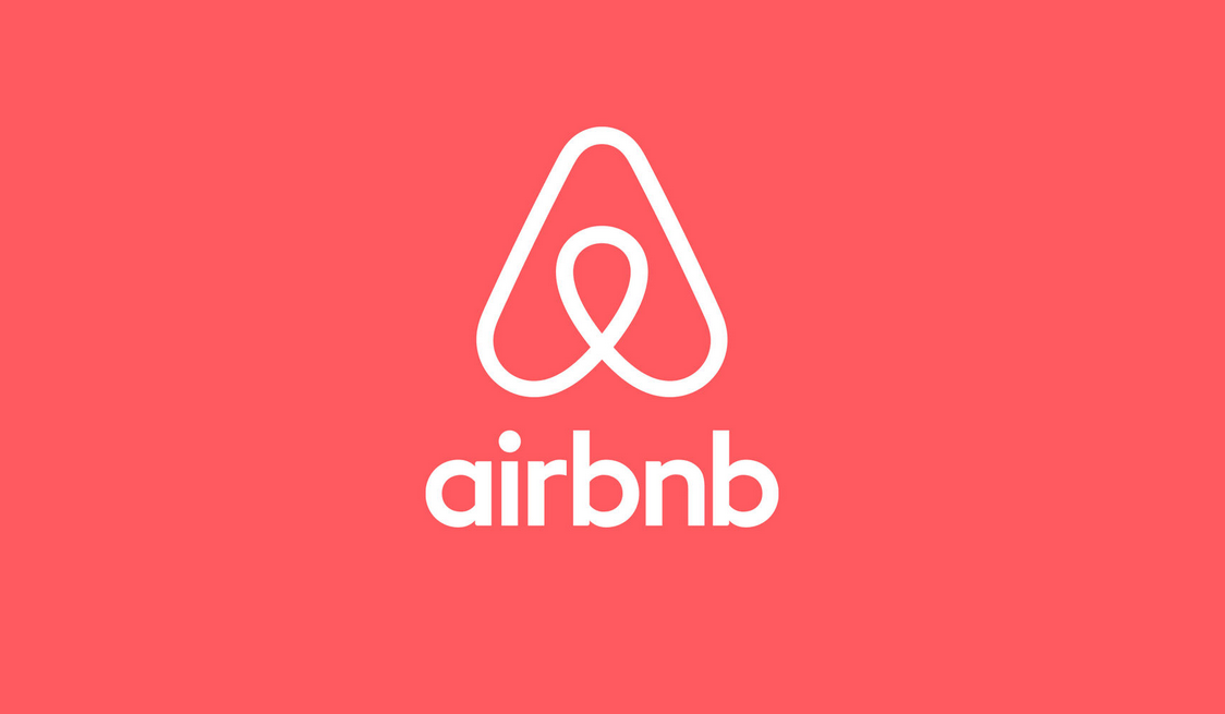 Airbnb logo on a red background.